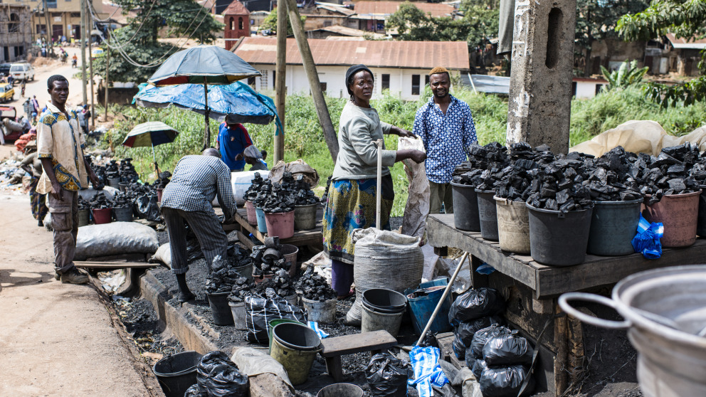 Auf einem Markt in der kamerunischen Hauptstadt Yaoundé verkaufen Händler Kohle, die unter anderem für Kochherde genutzt wird. Viele Entwicklungsländer haben nur wenig Zugang zu Energiewende-Zukunftstechnologien.